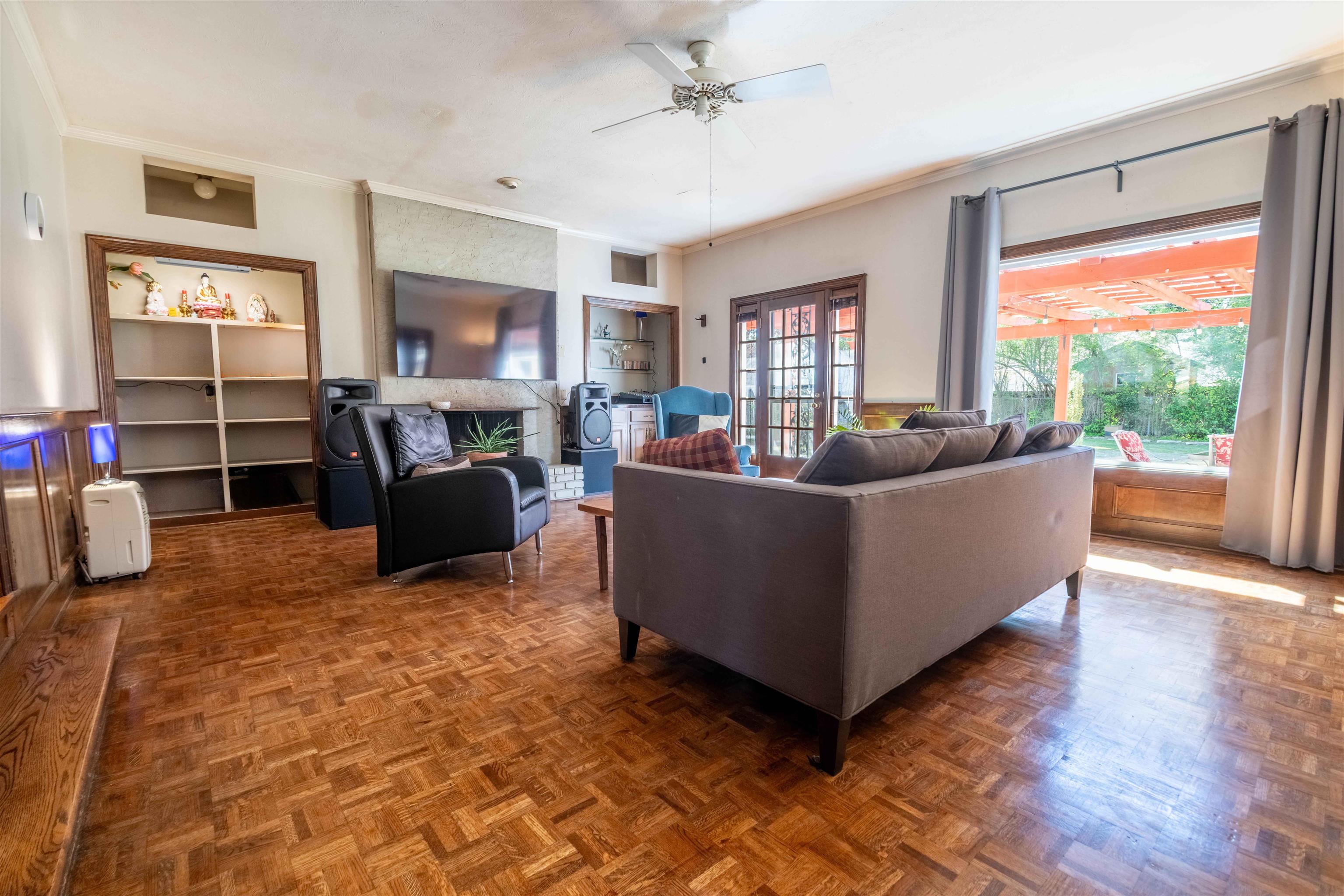 5099 Walnut Grove Road Memphis, TN 38117 - Photo 12 of 24 Living area with crown molding, parquet flooring, a brick fireplace, a ceiling fan, and french doors