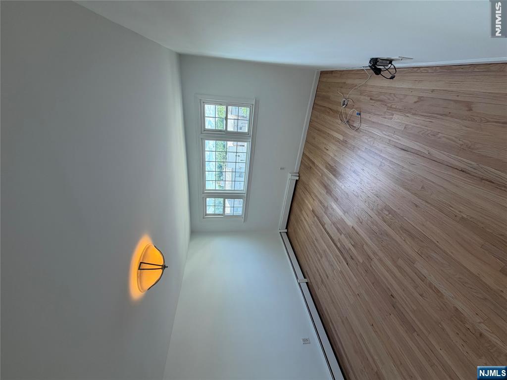 53 Devon Terrace, Unit 2 Kearny, NJ 07032 - Photo 6 of 15 a view of empty room with window and wooden floor