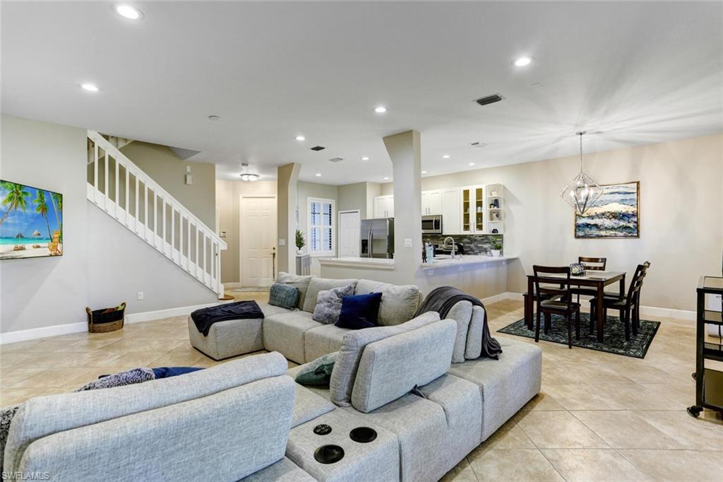 14966 Summit Pl Circle Naples, FL 34119 - Photo 1 of 14 a living room with furniture and a wooden floor