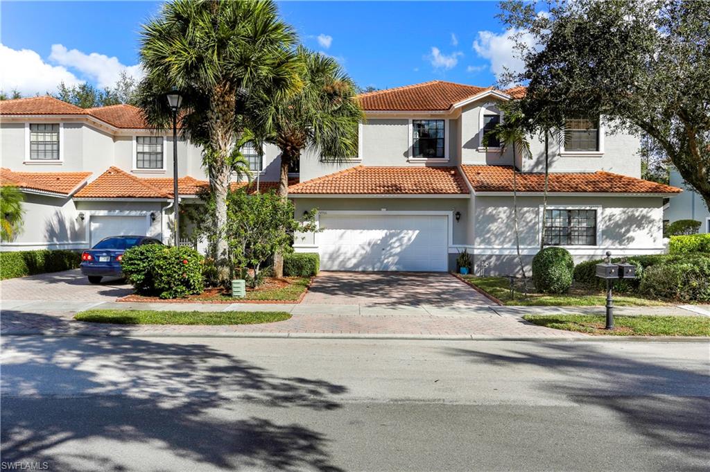 14966 Summit Pl Circle Naples, FL 34119 - Photo 12 of 14 a front view of a house with a yard