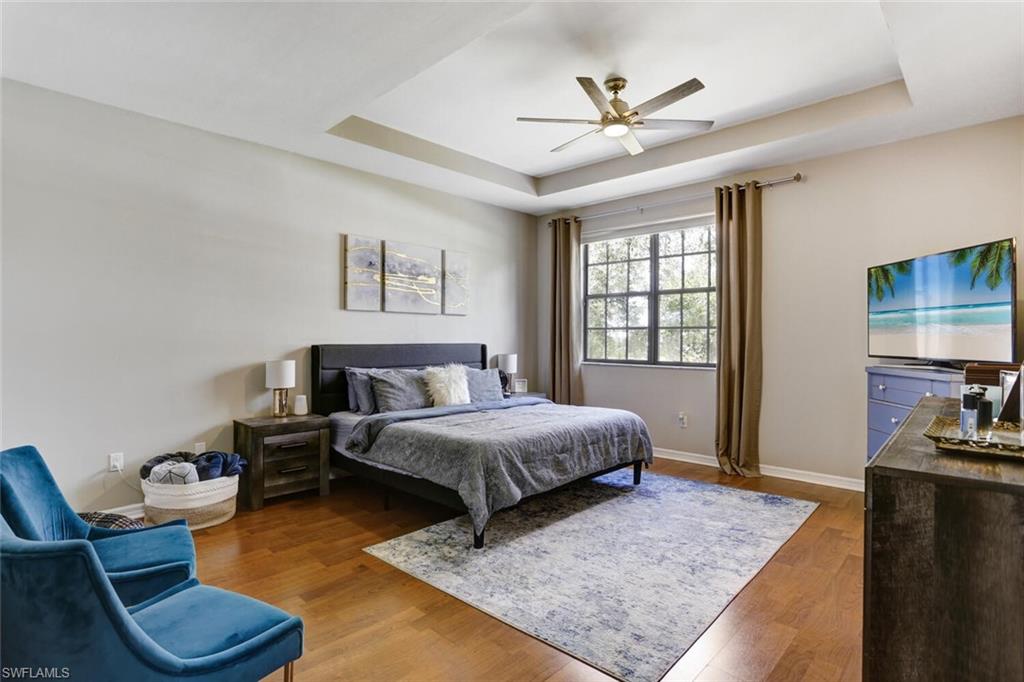 14966 Summit Pl Circle Naples, FL 34119 - Photo 2 of 14 a spacious bedroom with a bed and dresser