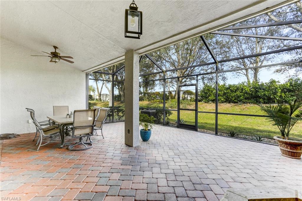 14966 Summit Pl Circle Naples, FL 34119 - Photo 3 of 14 a view of a porch with furniture and garden