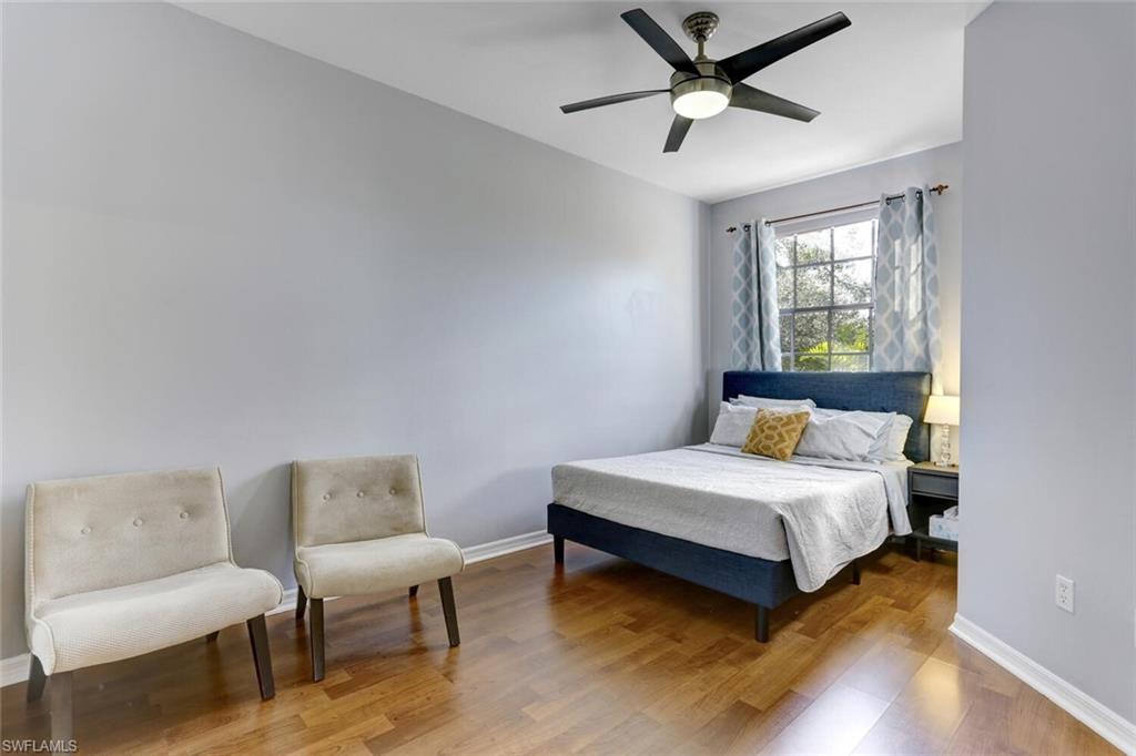 14966 Summit Pl Circle Naples, FL 34119 - Photo 5 of 14 a bedroom with a bed and a couch