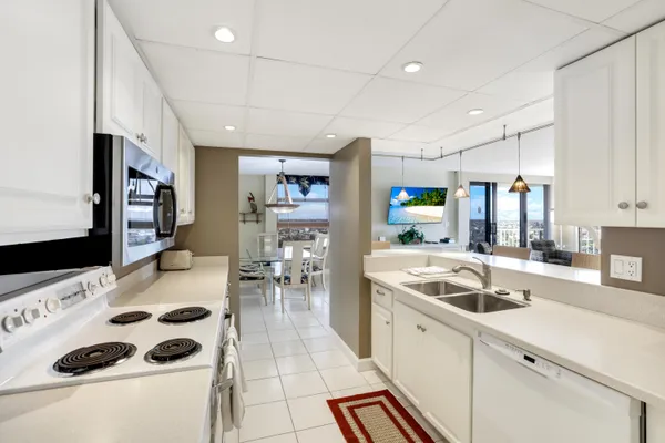 a kitchen with a sink a counter and cabinets
