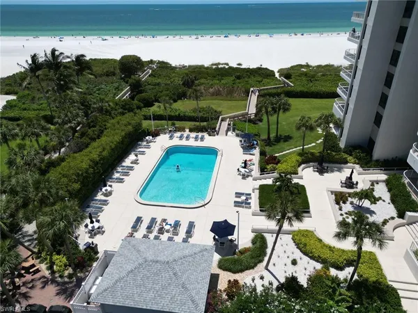 an aerial view of a house garden and ocean view