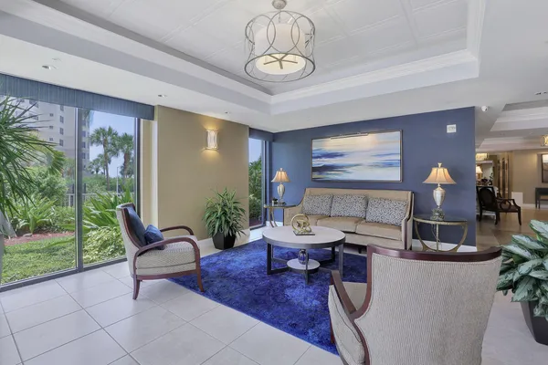 a living room with furniture and a floor to ceiling window