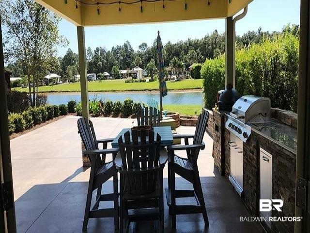 820 Carrozza Lane Foley, AL 36535 - Photo 2 of 45 View of patio with a water view, area for grilling, and a grill