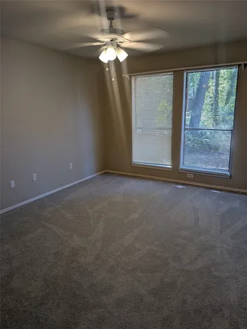 a view of a livingroom with an empty space and a window