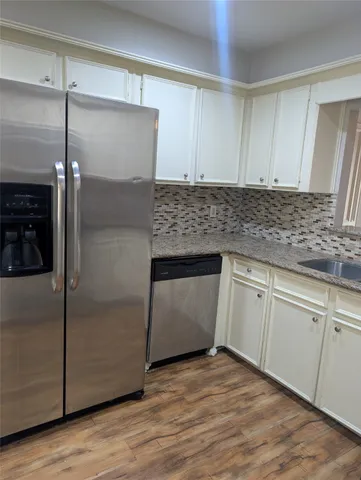 a kitchen with a refrigerator and a sink