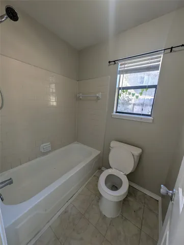 a bathroom with a toilet and a bathtub