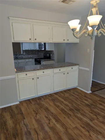a kitchen with cabinets and window