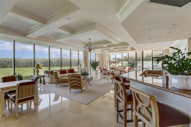 a spacious bedroom with a bed and a chandelier