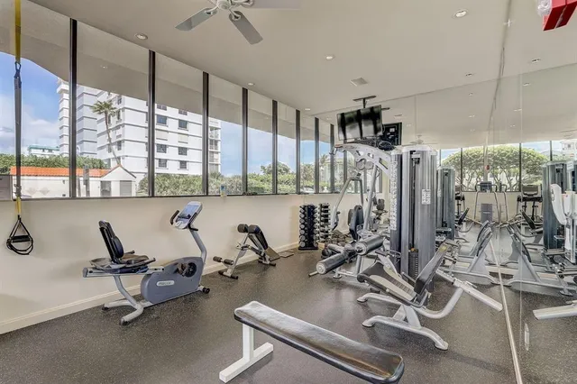 a bedroom with a bed and a ceiling fan