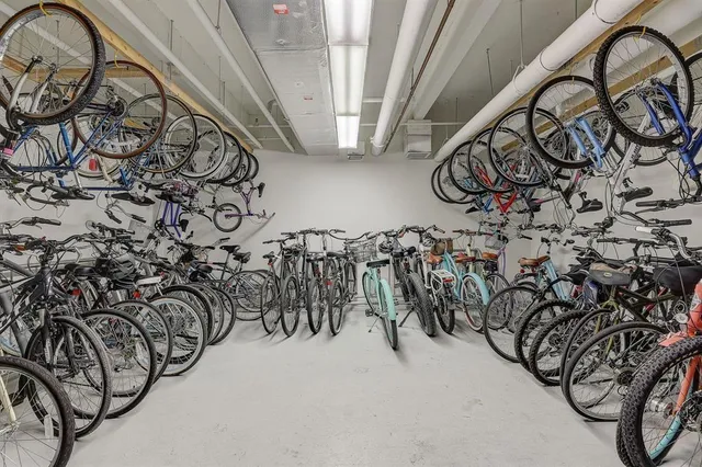 a living room with furniture a large window with white walls