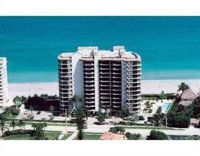 a view of a a dining room with furniture and a chandelier