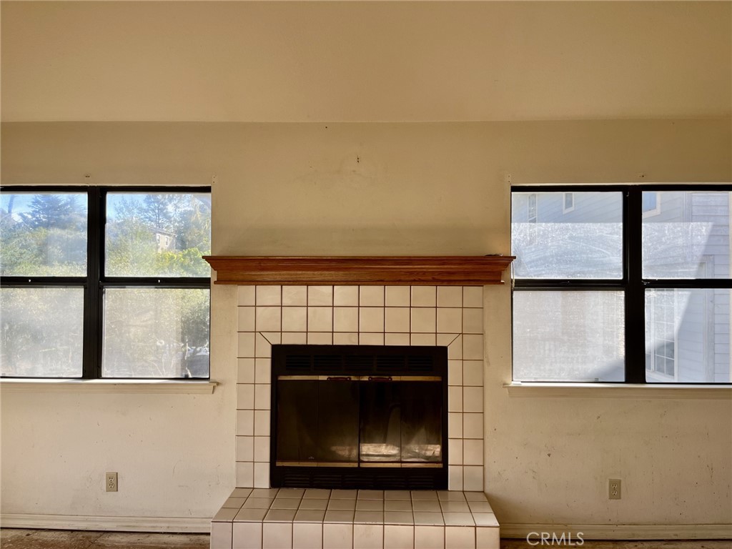 2387 Marjorie Place Cambria, CA 93428 - Photo 4 of 8 a living room with a fireplace