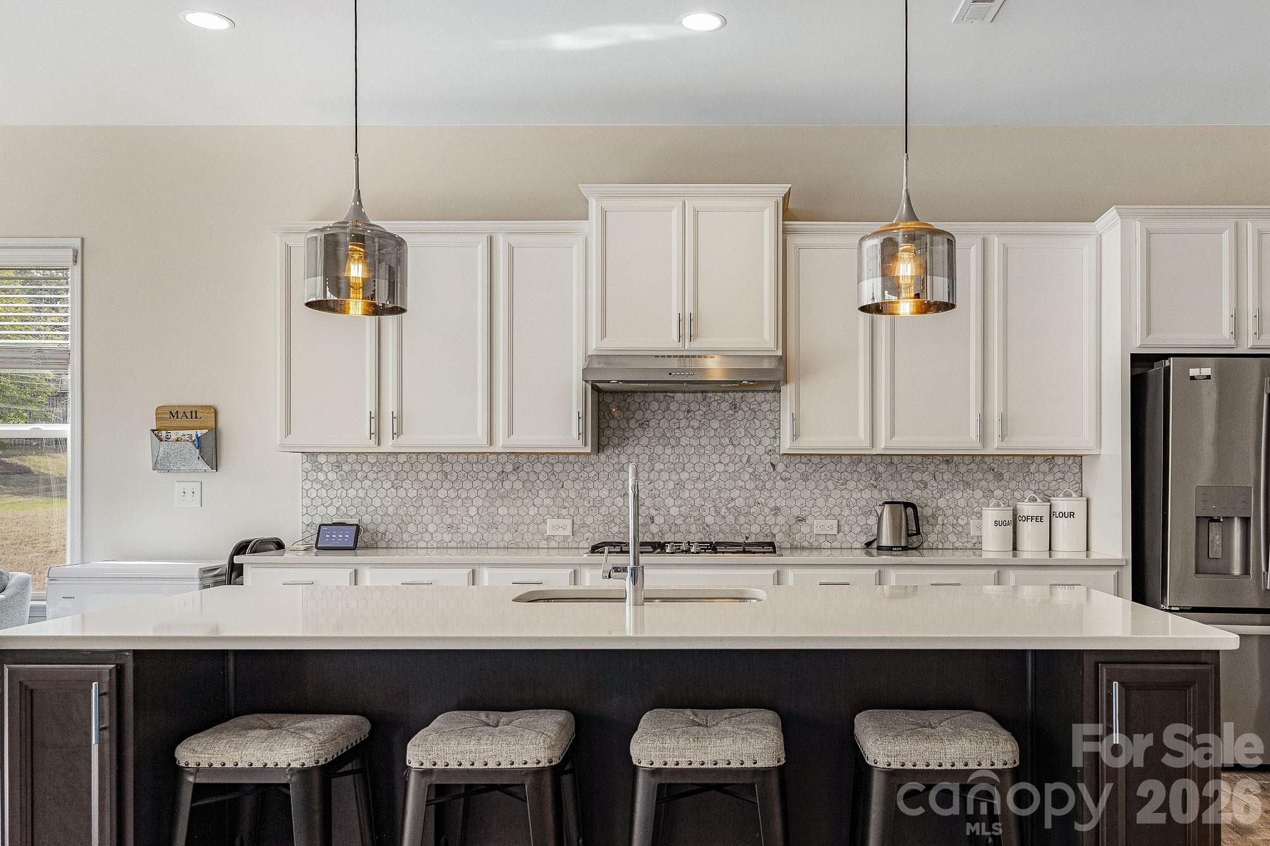 2036 Oliver Terrace Fort Mill, SC 29707 - Photo 14 of 41 a kitchen with stainless steel appliances a sink a stove a refrigerator a center island and chairs
