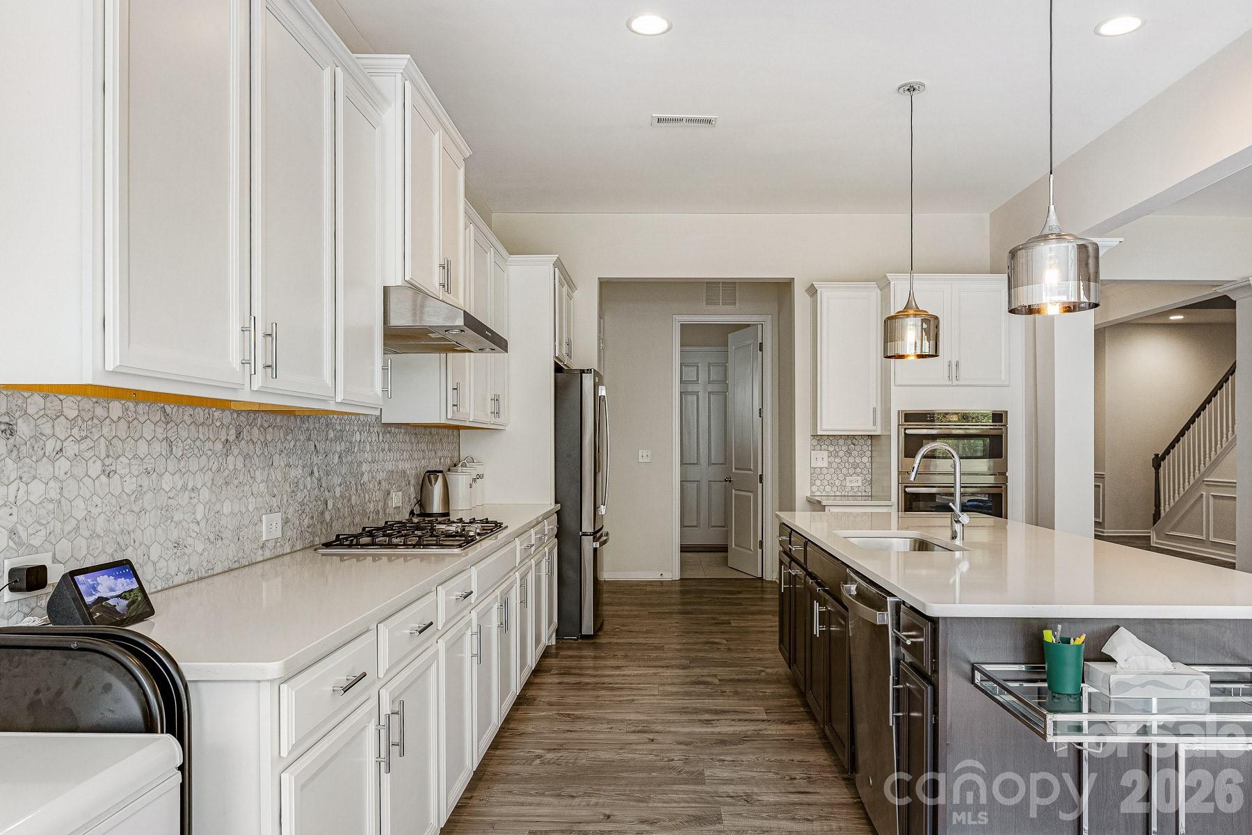 2036 Oliver Terrace Fort Mill, SC 29707 - Photo 16 of 41 a kitchen with kitchen island granite countertop lots of counter top space and stainless steel appliances