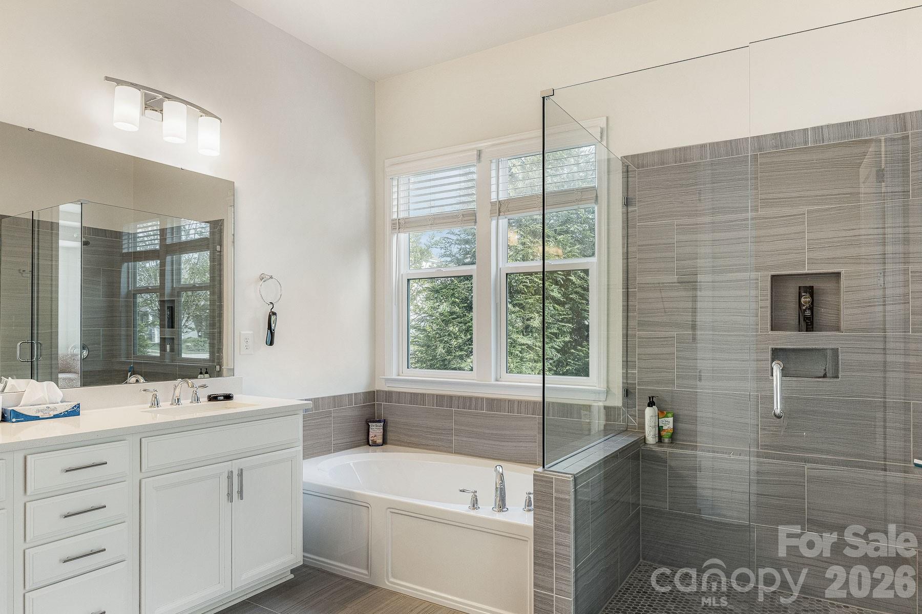 2036 Oliver Terrace Fort Mill, SC 29707 - Photo 22 of 41 a bathroom with a double vanity sink a mirror and a bathtub