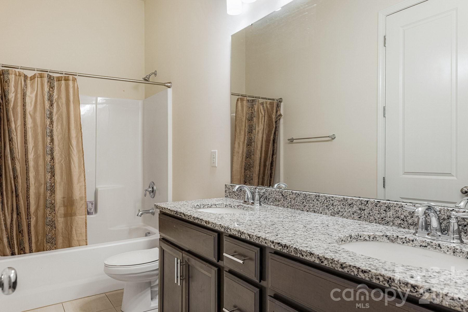 2036 Oliver Terrace Fort Mill, SC 29707 - Photo 32 of 41 a bathroom with a granite countertop sink a toilet and shower