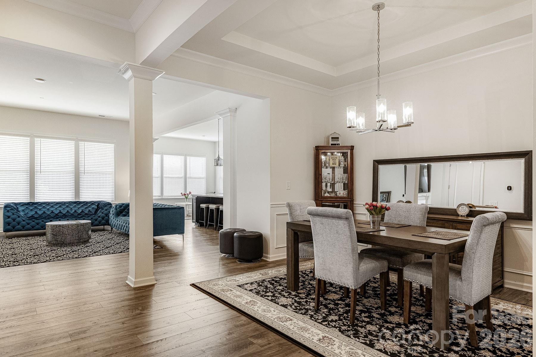 2036 Oliver Terrace Fort Mill, SC 29707 - Photo 5 of 41 a view of a dining room and livingroom with furniture wooden floor a chandelier