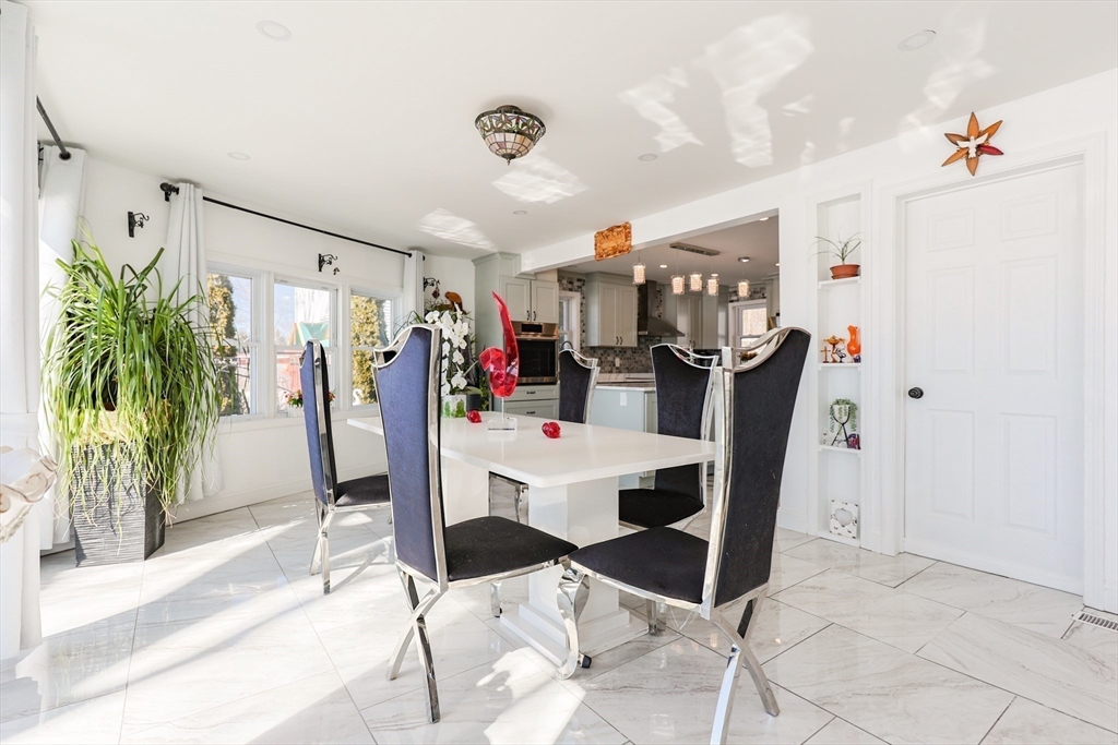 207 White Pond Road Lancaster, MA 01523 - Photo 11 of 38 a view of a dining room with furniture and a potted plant