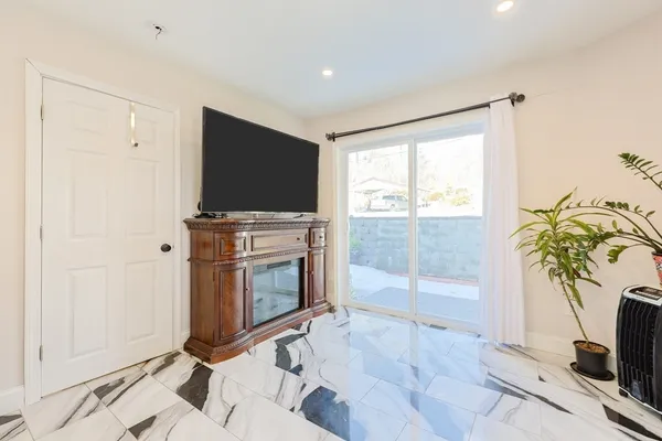 a bathroom with a glass shower door and a window