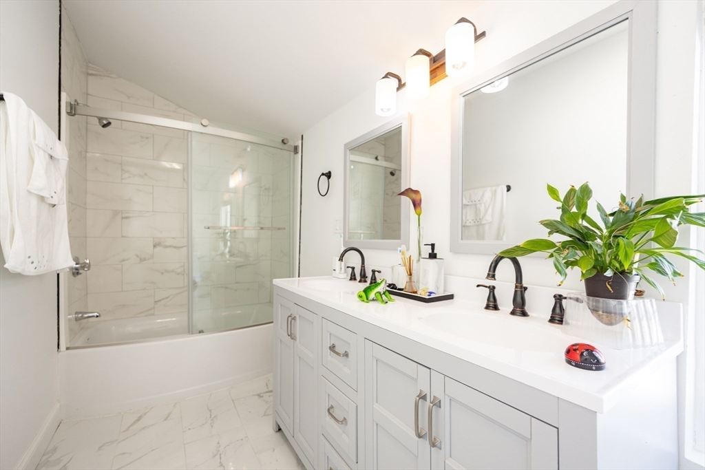 207 White Pond Road Lancaster, MA 01523 - Photo 23 of 38 a bathroom with a shower sink and mirror