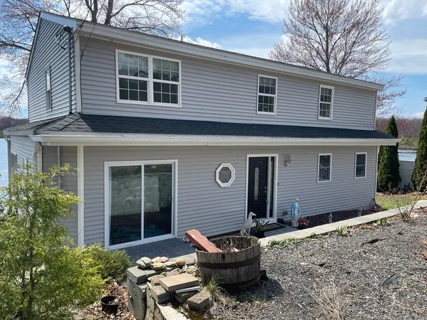 a backyard of a house with outdoor seating and barbeque oven