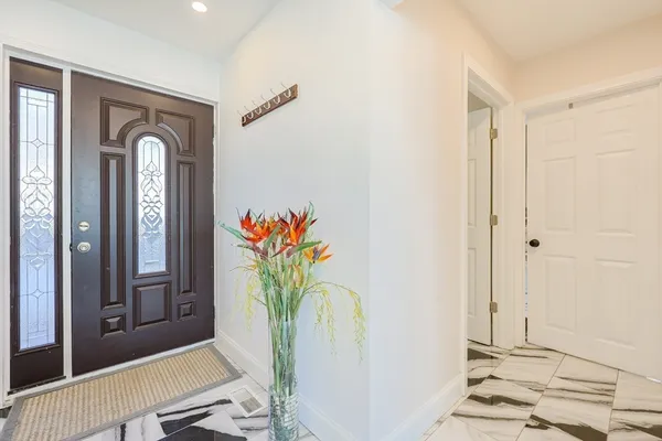 a view of entryway with furniture and wooden floor