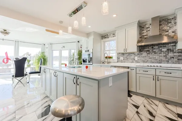 a kitchen with white cabinets and white appliances