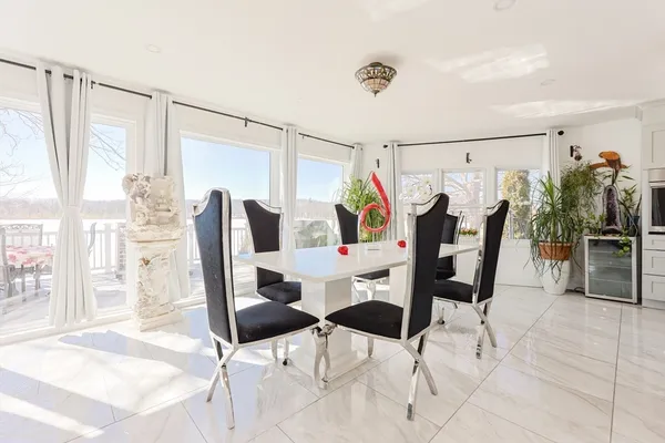 a view of a dining room with furniture and a potted plant