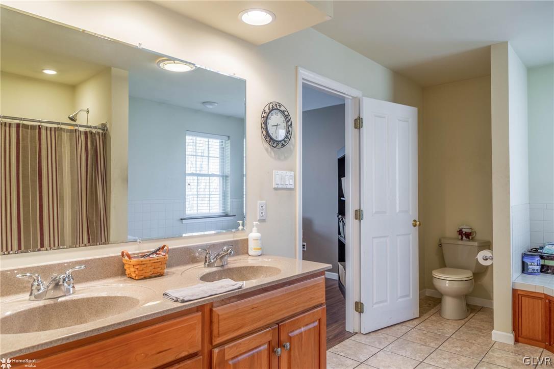 269 Germanville Road Ashland, PA 17921 - Photo 16 of 36 a spacious bathroom with a granite countertop sink toilet a large mirror a shower and a bathtub