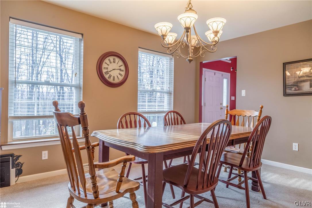 269 Germanville Road Ashland, PA 17921 - Photo 7 of 36 a dining room with wooden floor a chandelier a wooden table and chairs