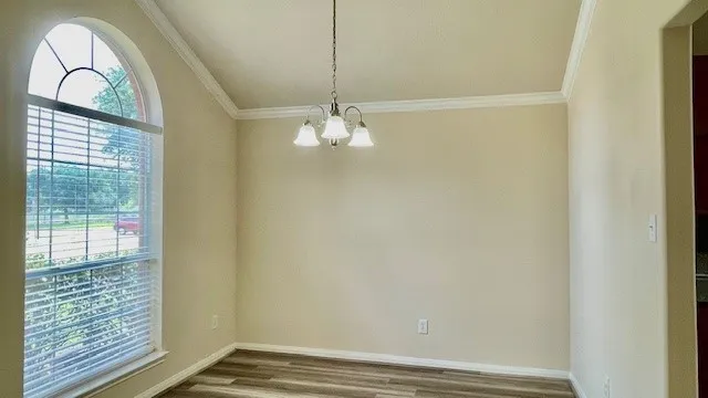 a view of a livingroom with wooden floor and window