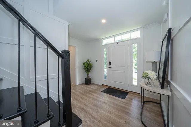 a view of entryway with wooden floor and stairs