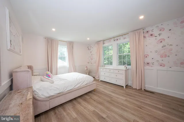 a bedroom with a large bed and a window