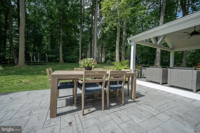 a view of a patio with a dining table and chairs
