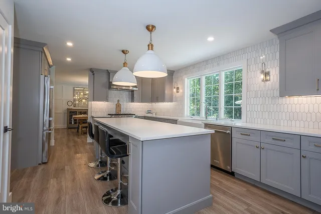 a kitchen with granite countertop a sink appliances and cabinets
