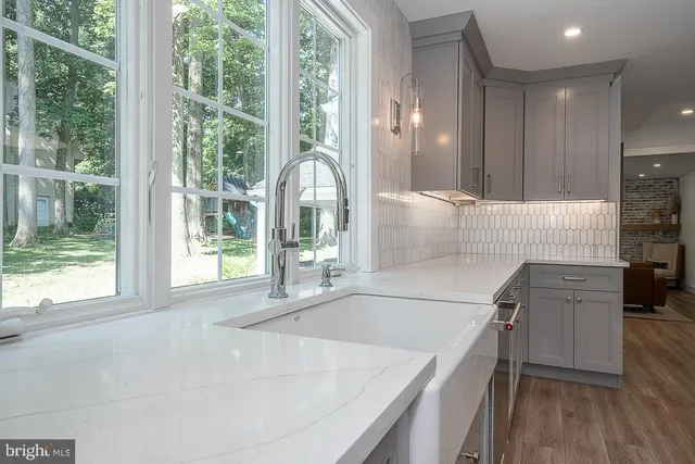 a kitchen with a sink and large cabinets