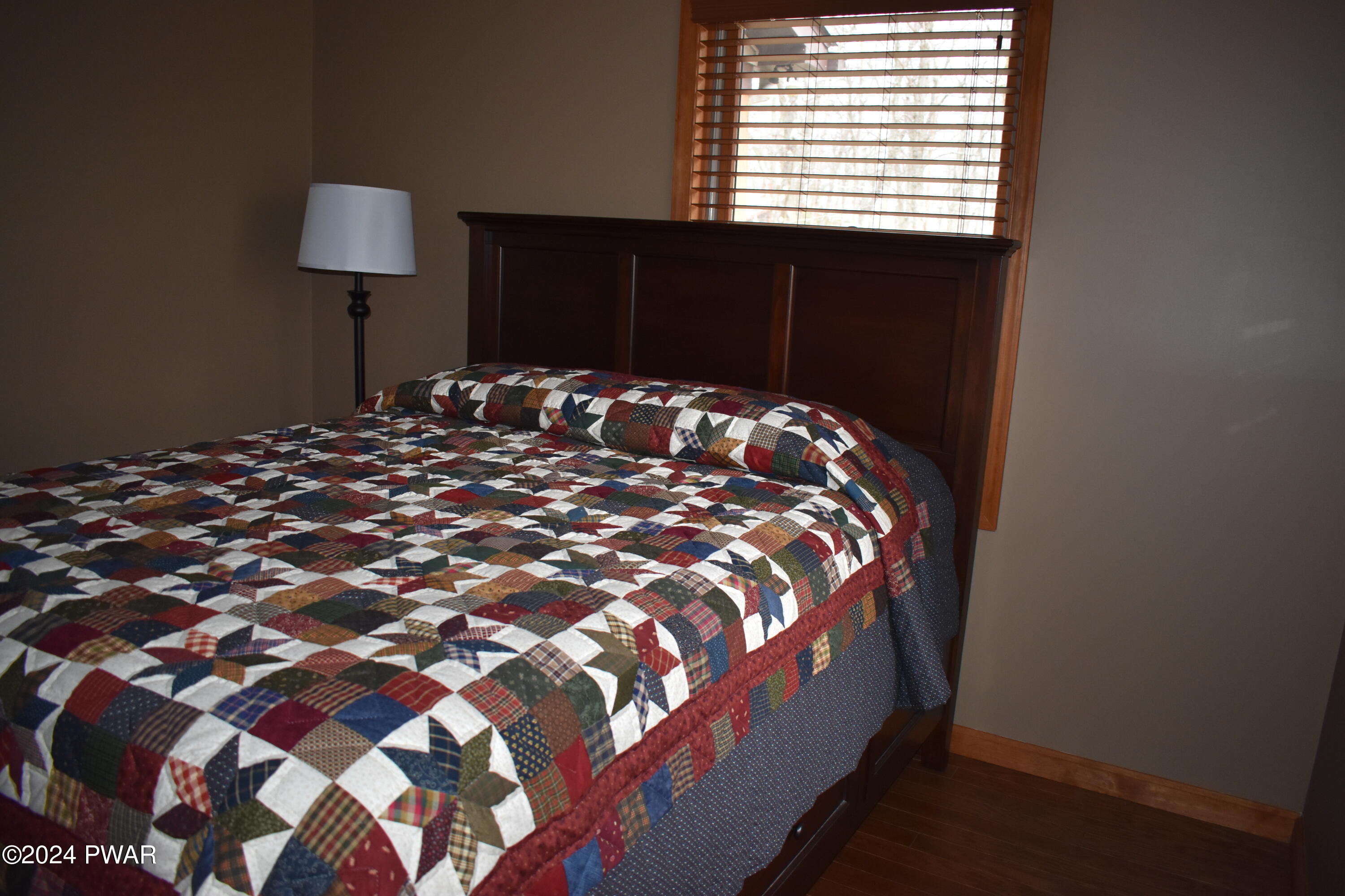 800 Rimrock Court Hawley, PA 18428 - Photo 13 of 30 a bed sitting in a bedroom next to a lamp