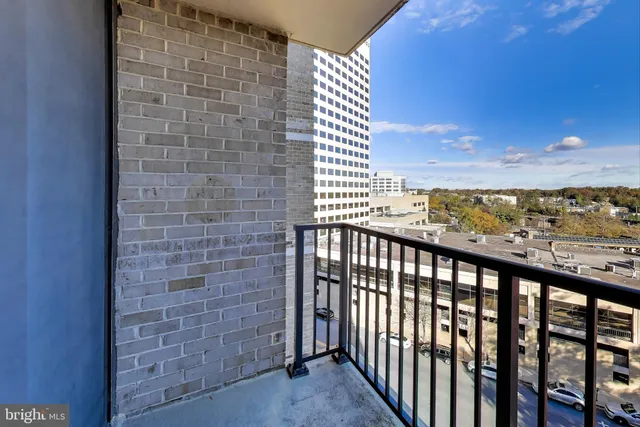 a view of staircase with railing and white walls