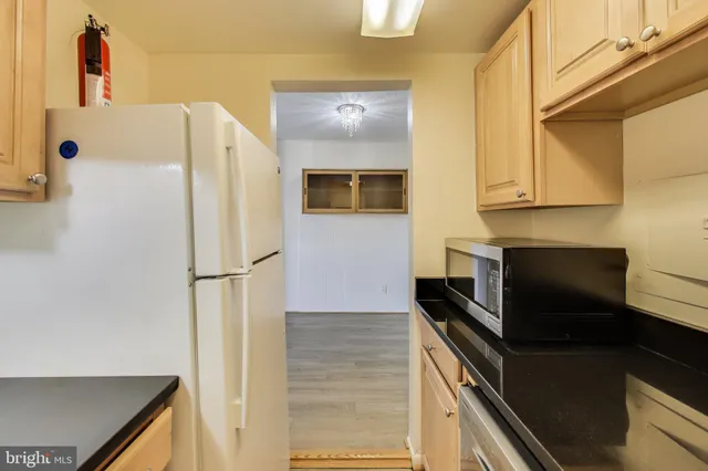 a kitchen with a refrigerator and a stove