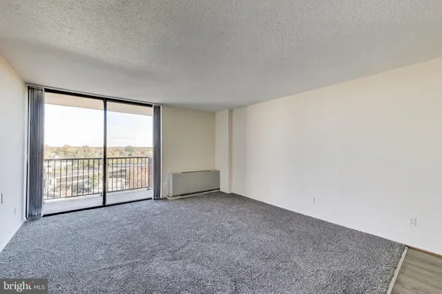 an empty room with sliding glass door