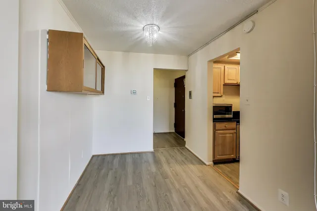 a view of hallway with wooden floor