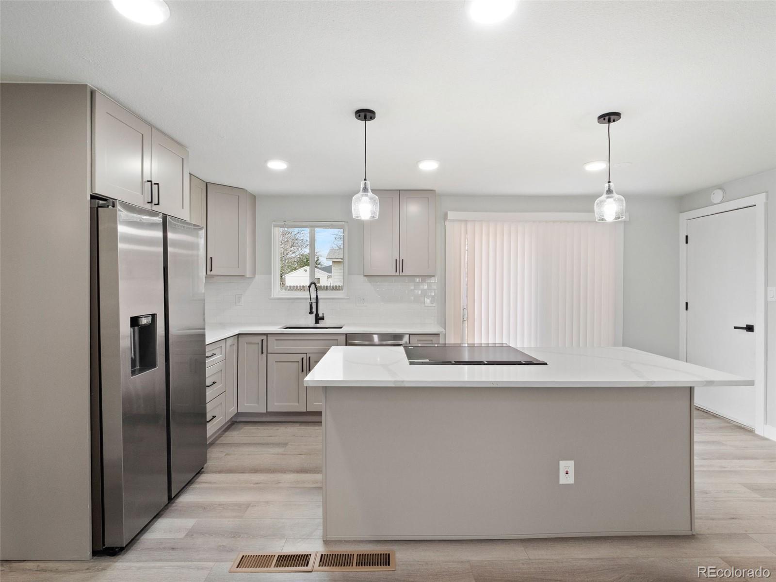 1035 6th Street Berthoud, CO 80513 - Photo 11 of 30 a view of a kitchen counter kitchen island