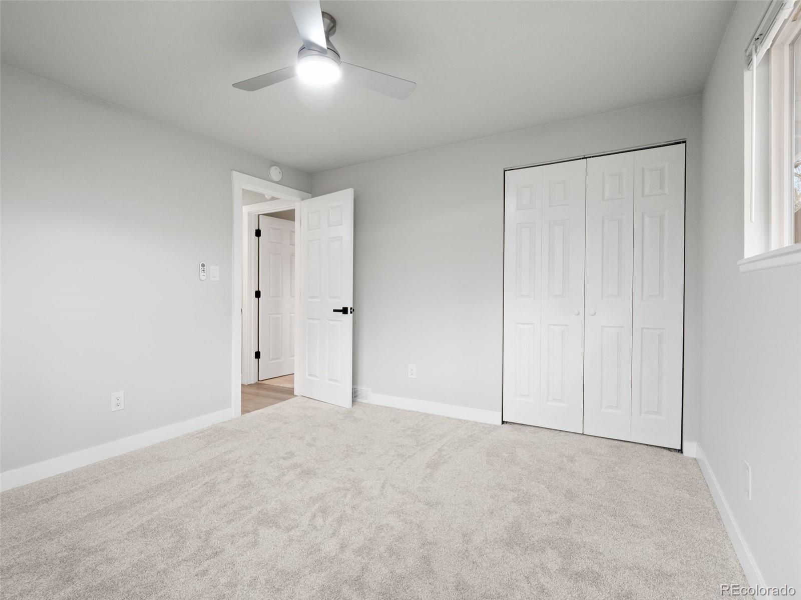 1035 6th Street Berthoud, CO 80513 - Photo 17 of 30 a view of an empty room and a window
