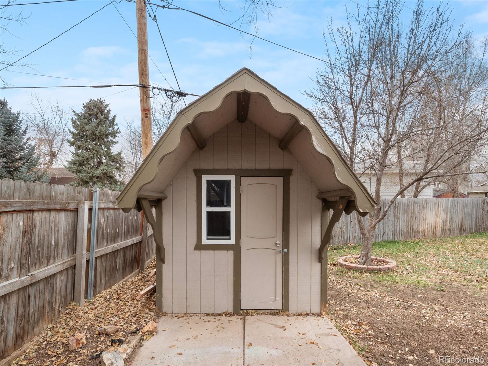 1035 6th Street Berthoud, CO 80513 - Photo 26 of 30 a view of a small house with a small yard