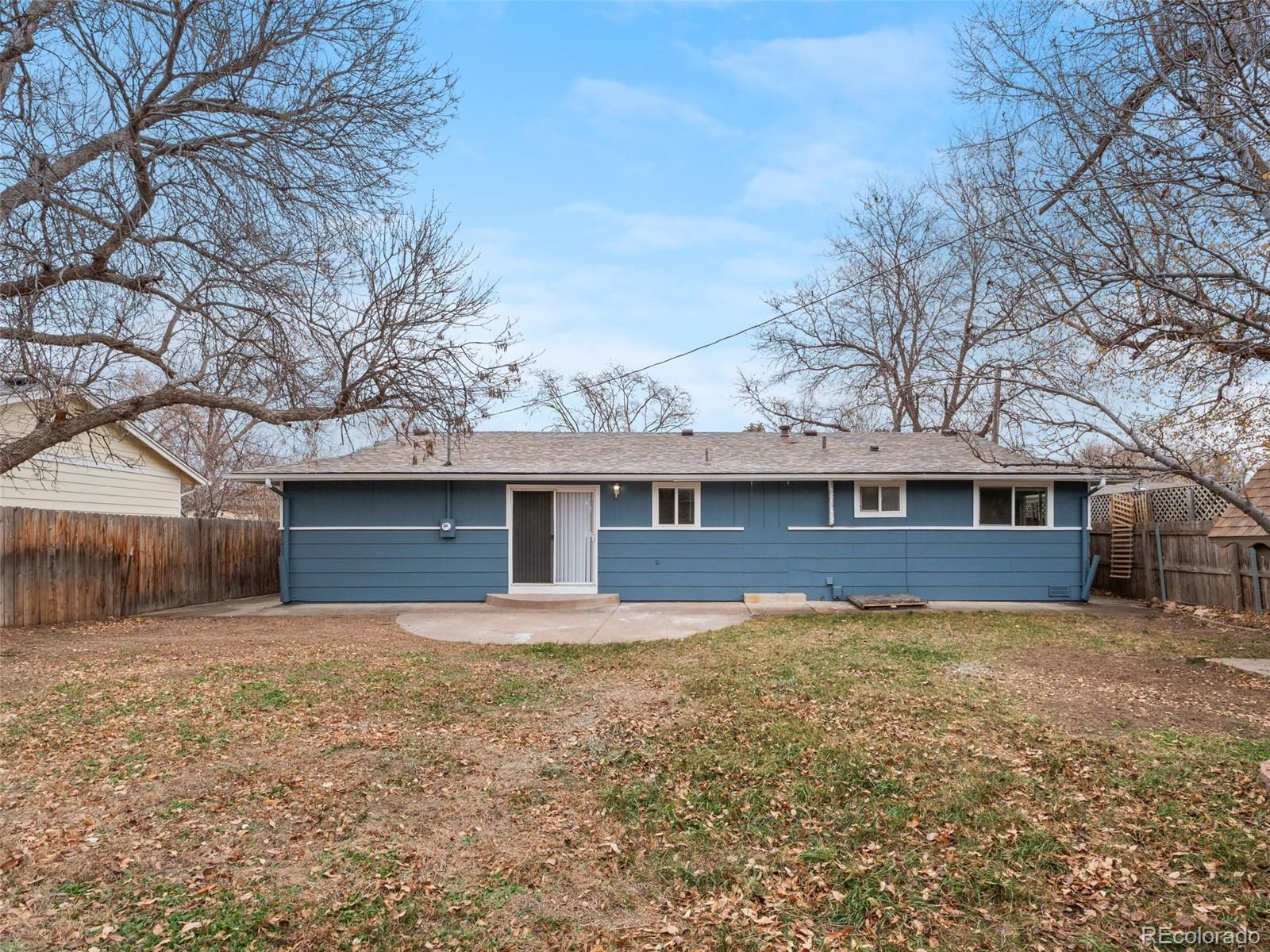 1035 6th Street Berthoud, CO 80513 - Photo 29 of 30 a front view of a house with yard and trees