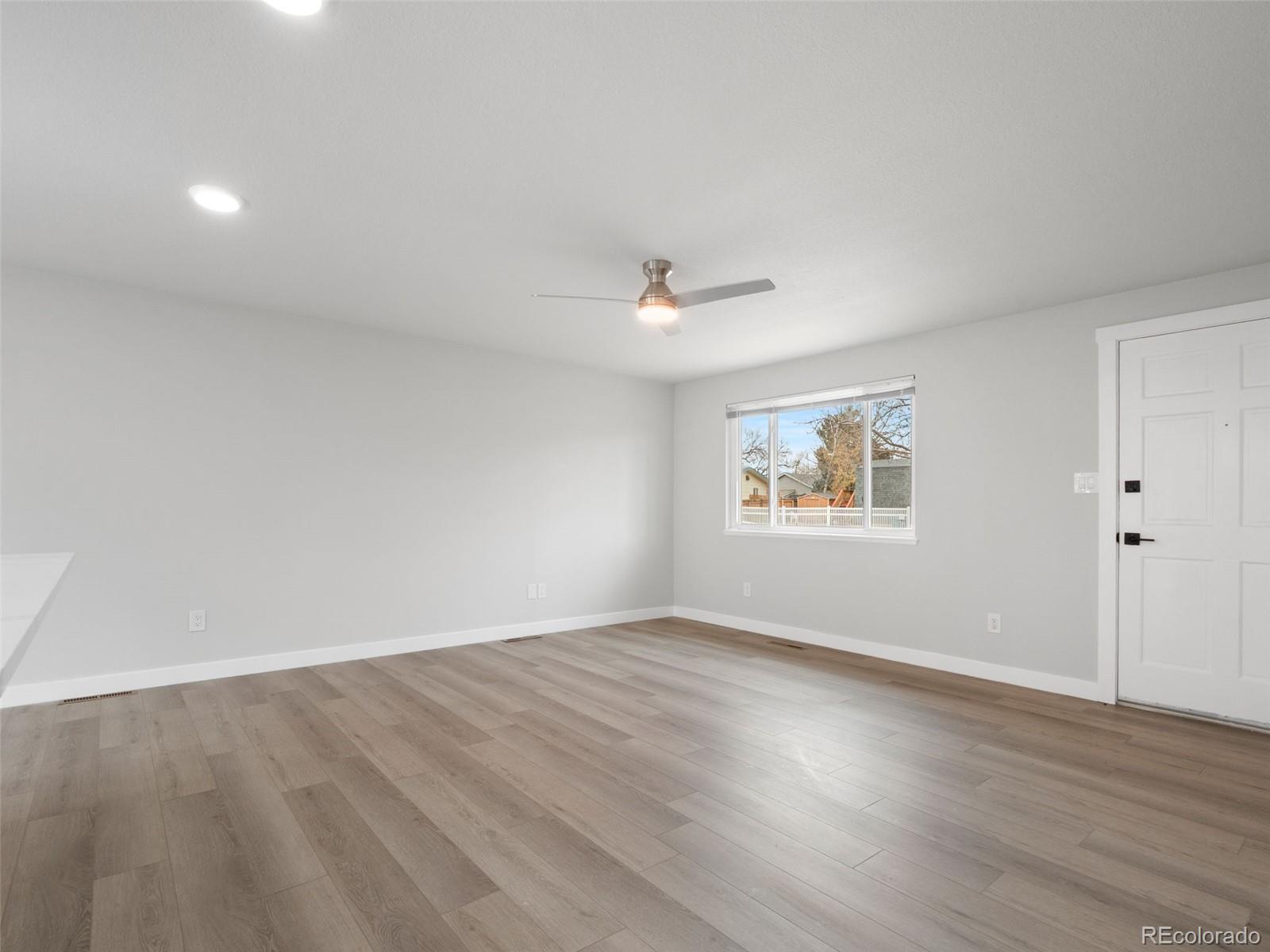 1035 6th Street Berthoud, CO 80513 - Photo 6 of 30 a view of an empty room with wooden floor